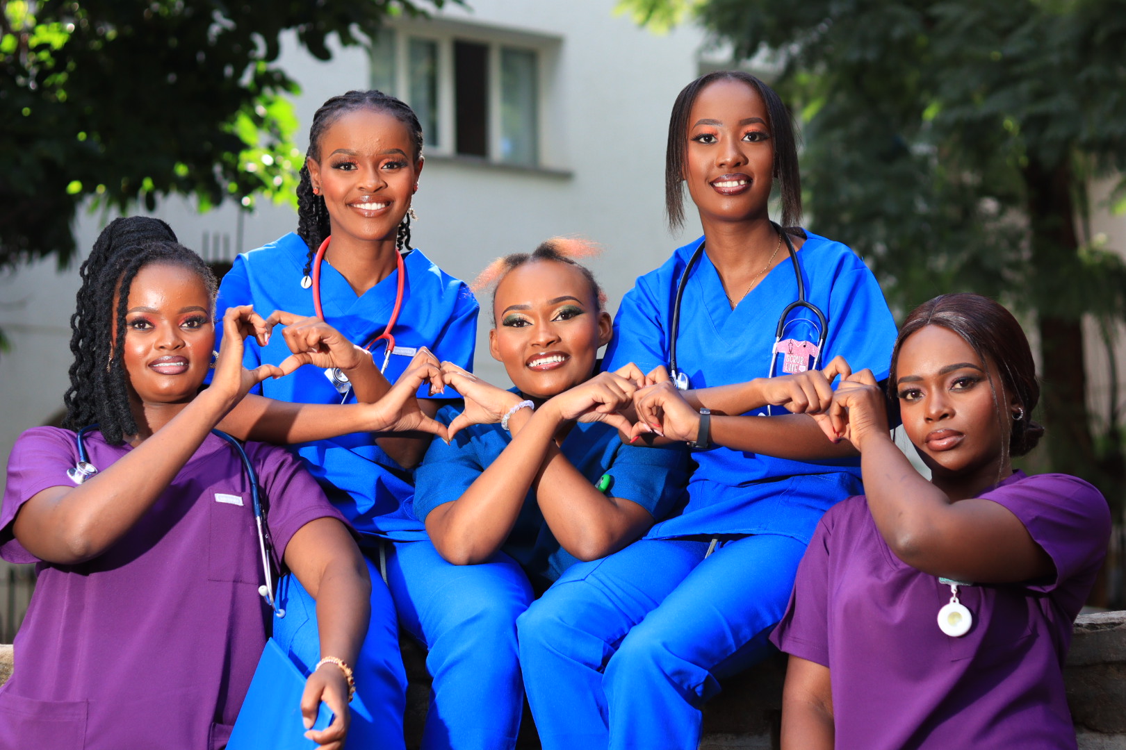 A diverse group of smiling caregivers standing together, signifying community and support.